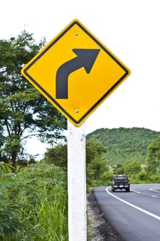 Right sharp curve traffic sign with road background