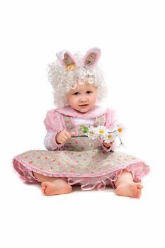 Little girl with flowers in hand wearing a dress. Isolated