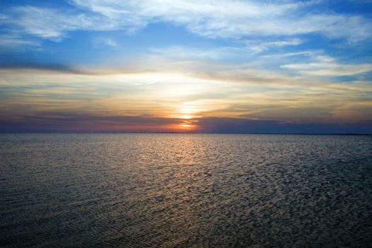 Beautiful sunset over a dark blue sea gulf
