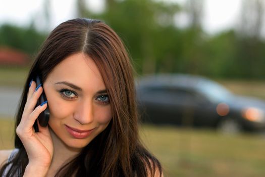 Smiling beautiful young woman calling by phone