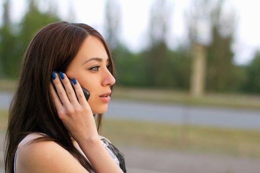 Beautiful young woman talking on the phone