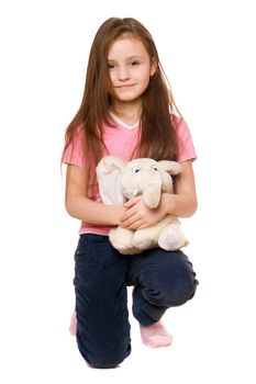 Pretty little girl with a teddy elephant. Isolated