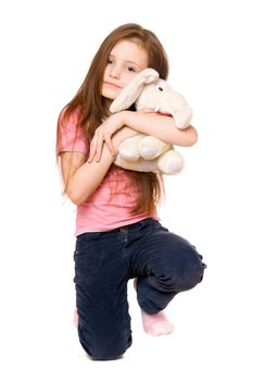 Happy little girl with a teddy elephant. Isolated