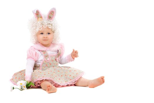 Baby girl with flowers in hand wearing a dress. Isolated