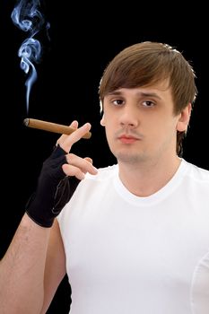 Young man with cigar. Isolated on black