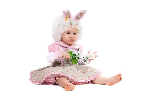 Baby girl with flowers in hand wearing a dress. Isolated on white