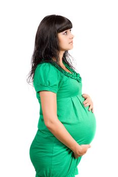 Portrait of a pregnant pretty girl in green dress