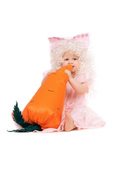 Baby girl plays with a carrot. Isolated