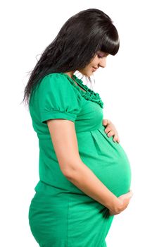 Portrait of a pregnant happy girl in green dress
