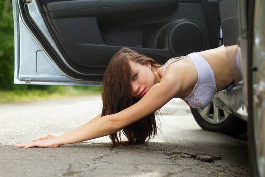 Playful young woman lying on the road