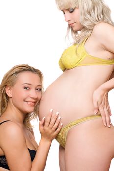 Pregnant woman with the smiling girlfriend. Isolated on white