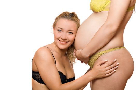 Happy young woman and belly of pregnant girlfriend