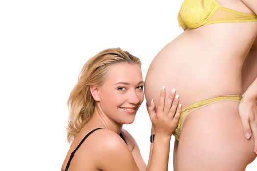 Smiling young woman and belly of pregnant girlfriend