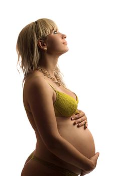 Happy pregnant young woman in yellow lingerie. Isolated