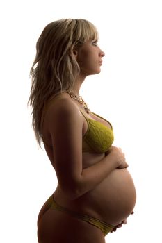 Pregnant young woman in yellow lingerie. Isolated