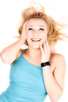 Portrait of joyful young blond girl lying on a white