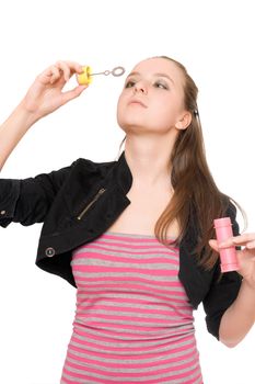 Portrait of pretty young woman blow bubbles. Isolated