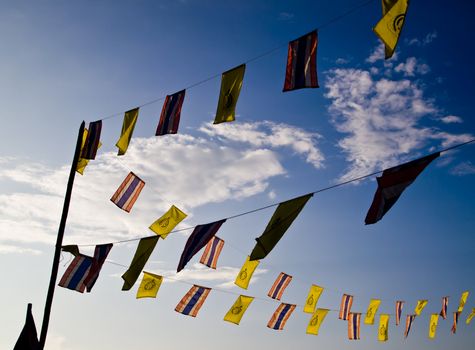 Buddhist and Thailand flag on the blue sky