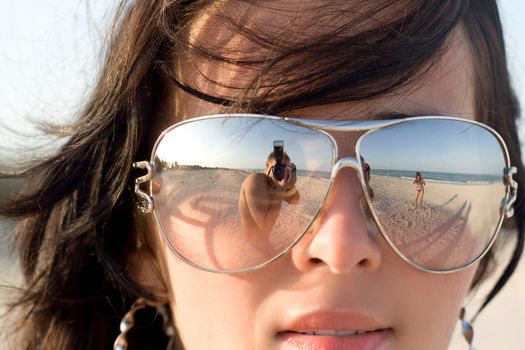 Reflexion of the photographer in model glasses