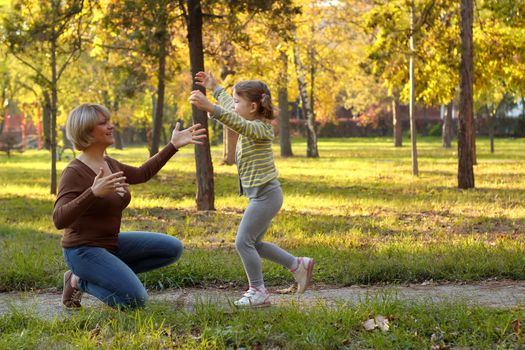 little girl running to embrace mother