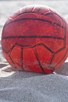 orange soccer ball on beach