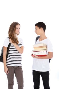 Teenage boy and girl with school supplies talking isolated on white in studio