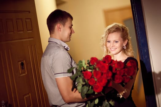 man gives red roses to a girl