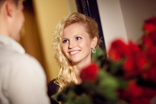 man gives red roses to a girl