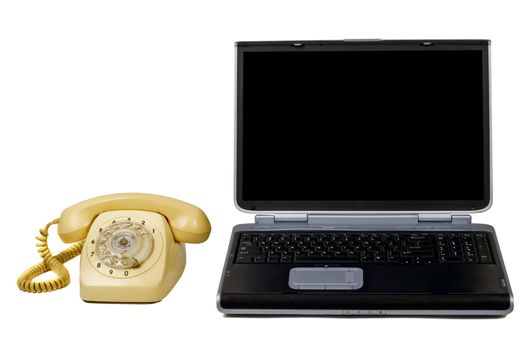 Laptop and old phone. Isolated on white