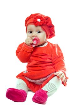 Nice baby girl sucking dummy. Isolated on white