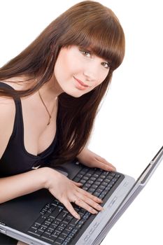 The young businesswoman sits with the laptop. Isolated
