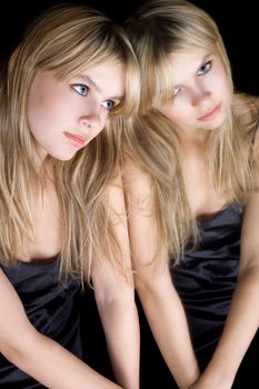 Portrait of the young blonde near a mirror