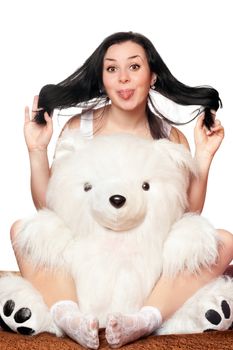 Cheerful girl with a big teddy bear