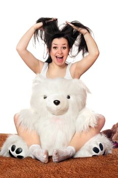 Joyful girl with a big teddy bear