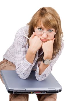The tired young woman sits with the laptop. Isolated