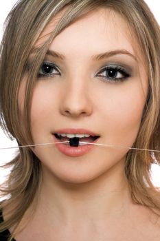 Close-up portrait of lovely young woman with a bead in her mouth
