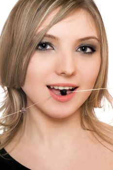 Close-up portrait of pretty girl with a bead in her mouth