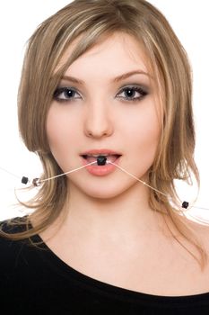 Close-up portrait of beautiful girl with a bead in her mouth