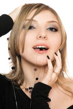 Close-up portrait of playful girl with a bead in her mouth
