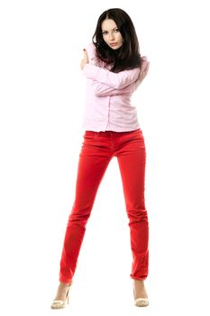 Attractive young brunette in pink shirt and red jeans