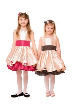 Two charming little girls in a dress. Isolated