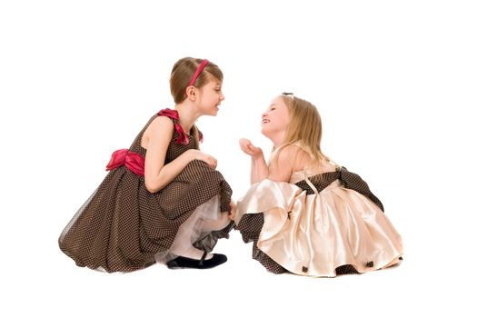 Two beautiful little girls talking. Isolated on white