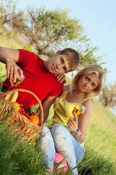 Attractive blonde and young man with wineglasses outdoors