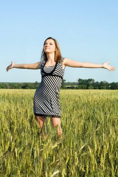 Happy attractive young woman in the field