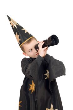 Boy dressed as astrologer looking through a telescope. Isolated