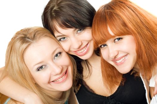 Portrait of three cheerful young women. Isolated on white