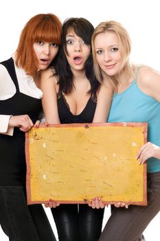 Three young surprised women taking vintage yellow board