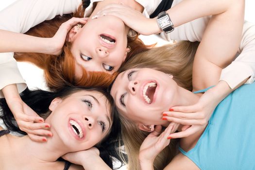 Portrait of three young smiling women on white background