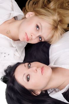 Portrait of lying young blonde and brunette