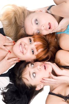 Portrait of three excited women lying on white background